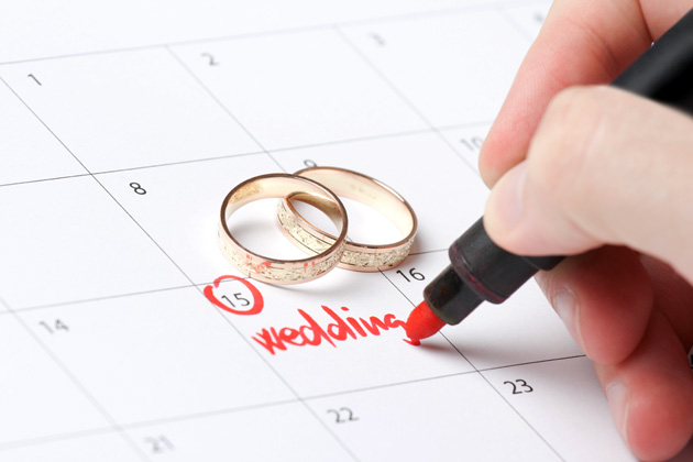 Picture of wedding rings and calendar.